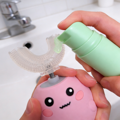 Person using sour apple kids toothpaste 